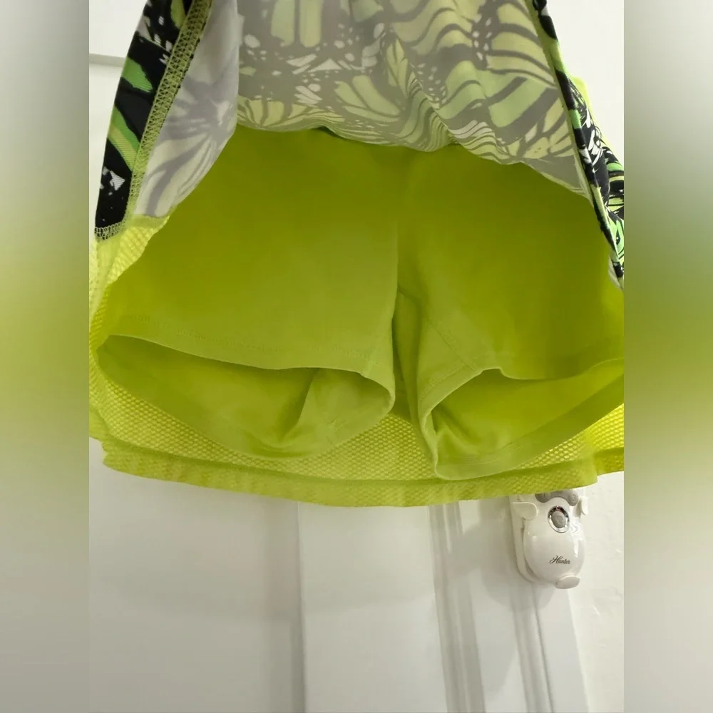 Fila neon yellow green mini skort w/ multicolor butterfly pattern